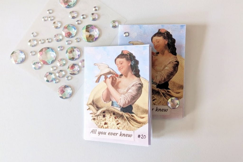 Zwei Mini-Zines, auf dem Titel eine Collage einer Frau mit weißer Taube, die in einer Muschel sitzt. Daneben Diamanten-Sticker.